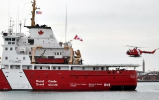 A Coast Guard pilot lands helicopter on deck of CCGS Griffon in St. Clair River.