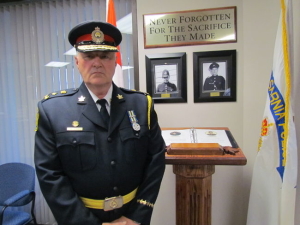 Chief Phil Nelson with memorial commemorating two Sarnia police officers killed in the line of duty.