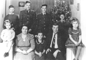 Jim Charron, with the family at Christmas, 1943, before shipping out. From left are: Wilfred, Jim, Fern Charron (in reserves and Yvon Charron; front row: Mary Rose, Alda , Collette, Adelard and Irene Charron. Charron family photo
